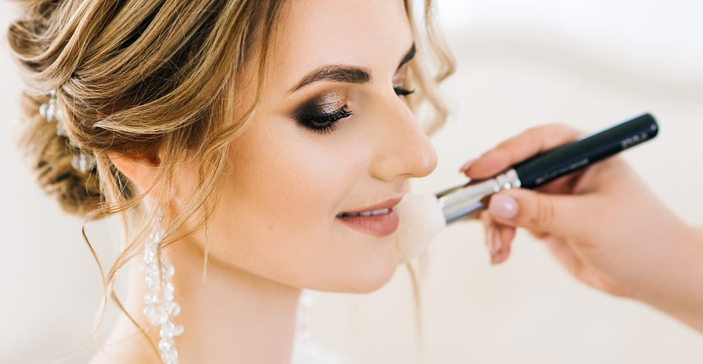 Close up of bride getting her wedding makeup done by a professional makeup artist