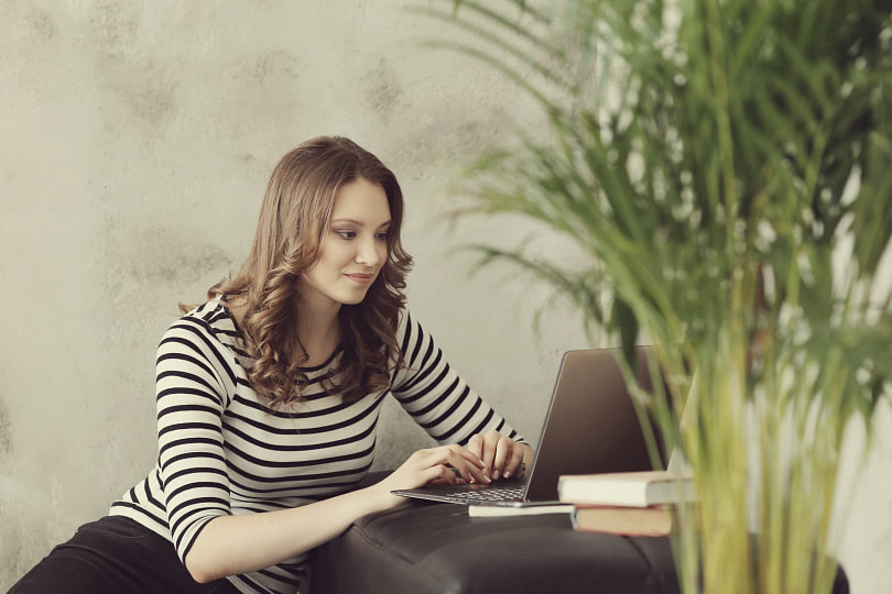 Woman on a laptop booking her bridal makeup artist online