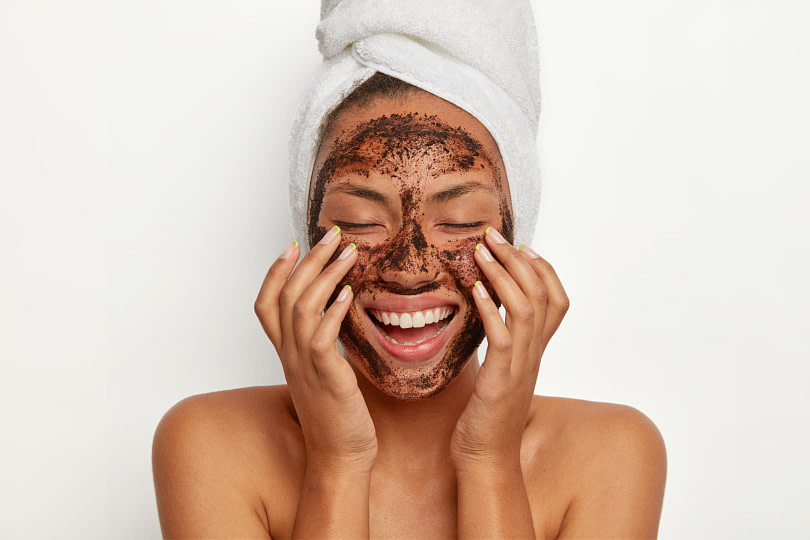 A woman exfoliating her skin